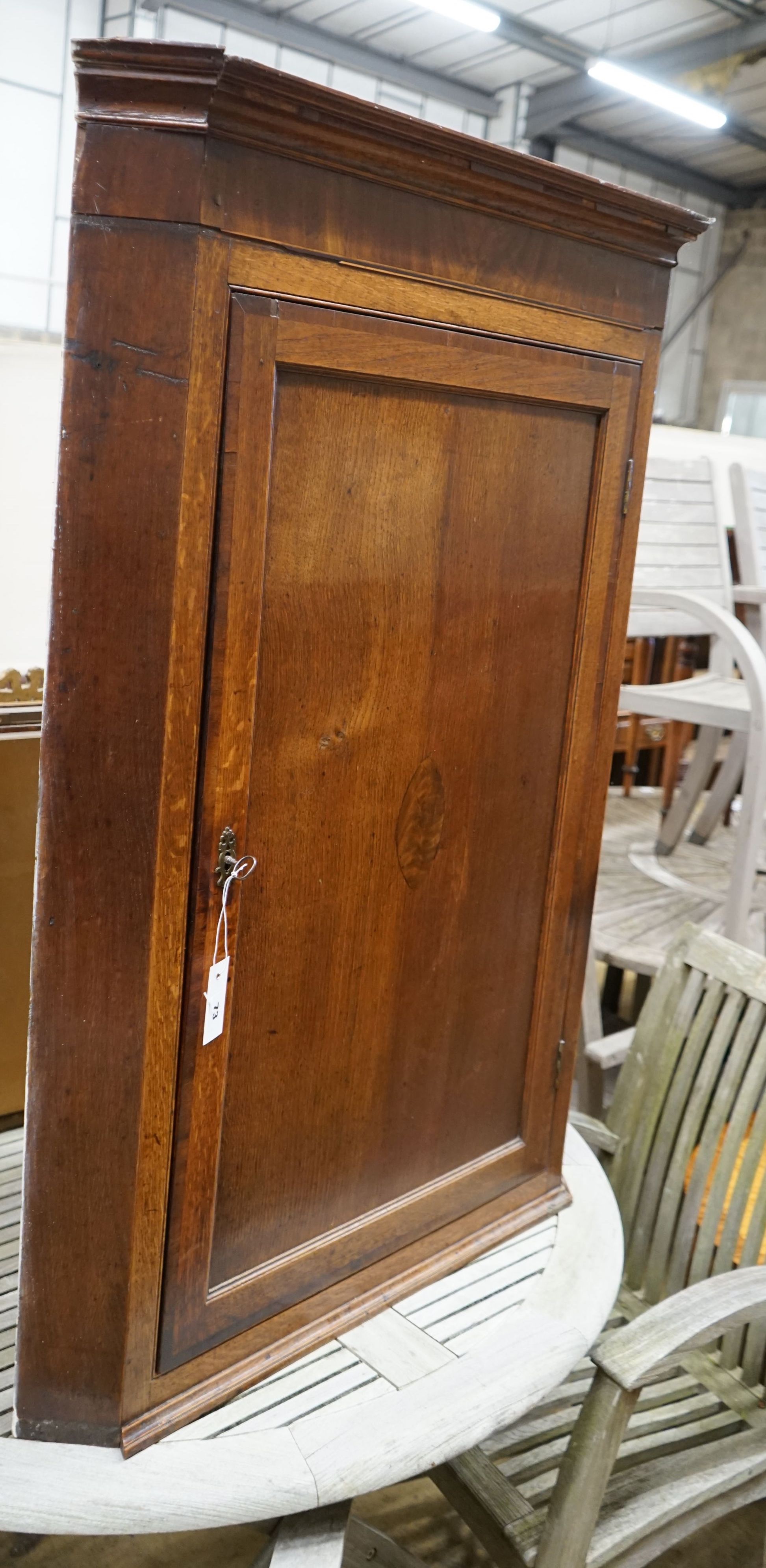 A George III mahogany banded oak hanging corner cabinet, width 82cm, depth 42cm, height 116cm